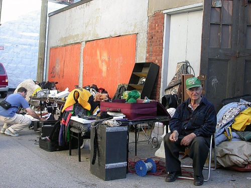 homeless man outside garage